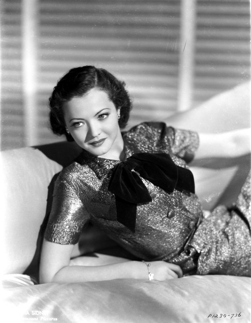 Sylvia Sidney in a Black Dress and Hand on Waist with Hat Photo Print - Item # VARCEL704469