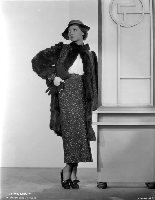 Sylvia Sidney wearing a Furry Coat with Printed Skirt and Hand Waist Photo Print - Item # VARCEL704525