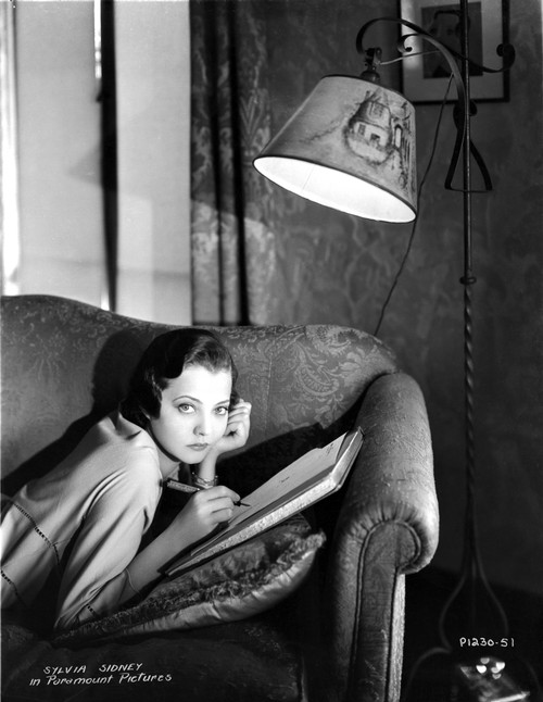 Sylvia Sidney Lying on Couch While Writing Photo Print - Item # VARCEL704537
