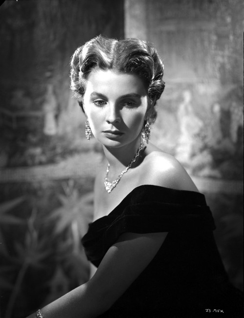 Jean Simmons Seated in Black Velvet Off-Shoulder Dress and Necklace with Dangling Earrings Photo Print - Item # VARCEL704710