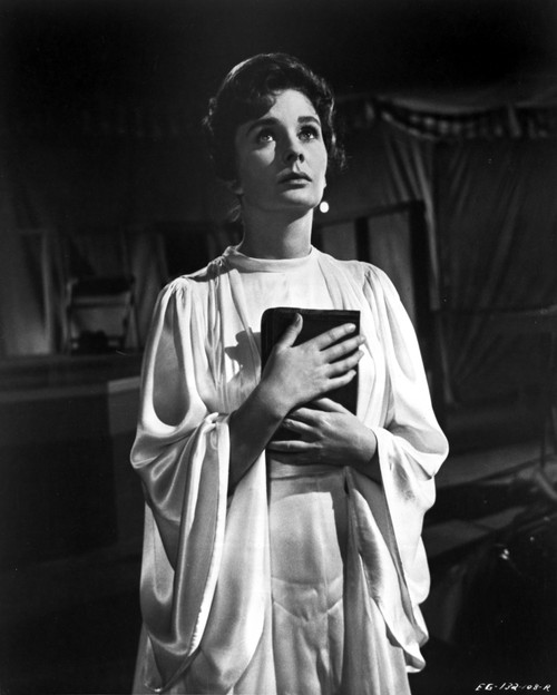 Jean Simmons Posed in White Butterfly Sleeve Silk Dress with Hands Together Holding a Black Book Photo Print - Item # VARCEL704712