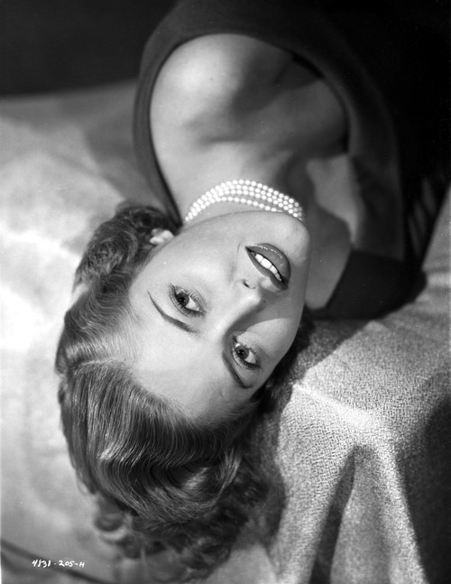 Martha Vickers Lying on Bed wearing Pearl Necklace Photo Print - Item # VARCEL705375
