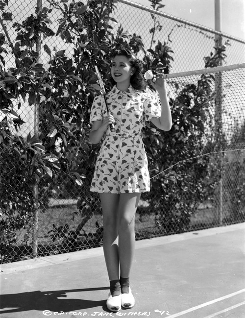 Jane Withers Posed in White Short Sleeve Blouse in Heart Print Pattern with Right Hand Holding a Tennis Racquet Photo Print - Item # VARCEL705615