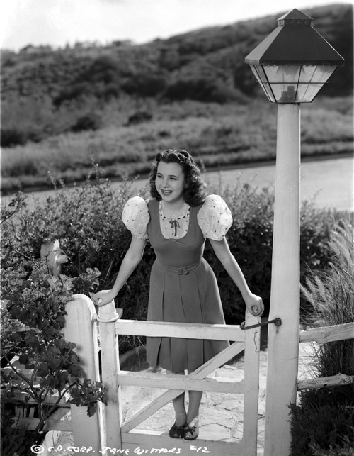Jane Withers Posed in Sheer Silk Sleeve Velvet Blouse with Hands on the Wood Fence Gate Photo Print - Item # VARCEL705617