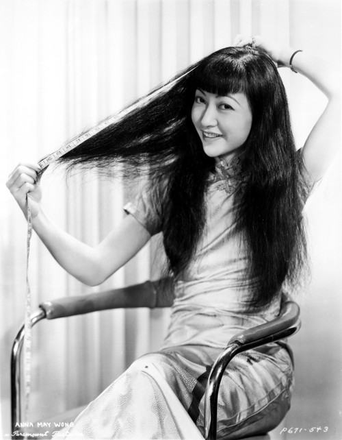 Anna Wong sitting on a Chair and Fixing Her Hair Photo Print - Item # VARCEL705667