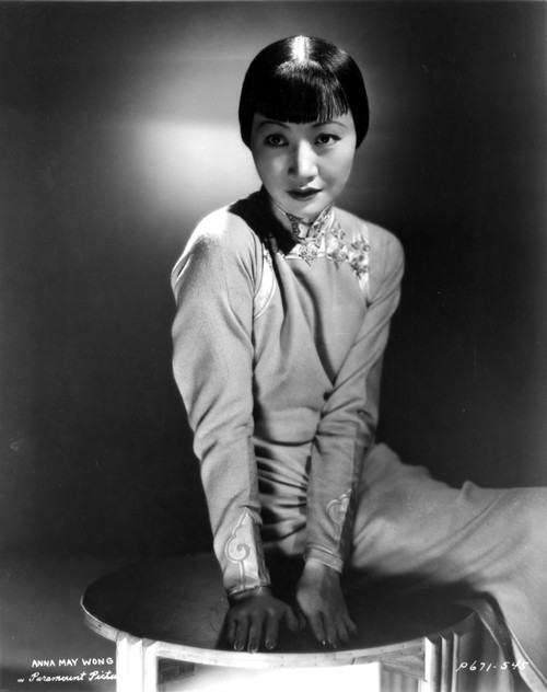 Anna Wong sitting on a Small Table and Looking Away From the Camera Photo Print - Item # VARCEL705687