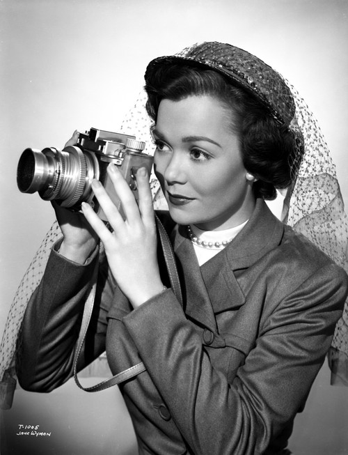 Jane Wyman Portrait in Grey Linen Long Sleeve Suit and White Round-Neck Shirt with Lace Flat Hat and Hands Holding a Camera Photo Print - Item # VARCEL705856