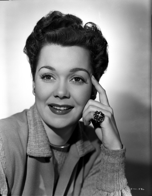Jane Wyman Portrait in Grey Linen Tweed Long Sleeve Shirt and Round Neck Cotton Shirt with Right Hand Finger Touching the Head in White Background Photo Print - Item # VARCEL705853