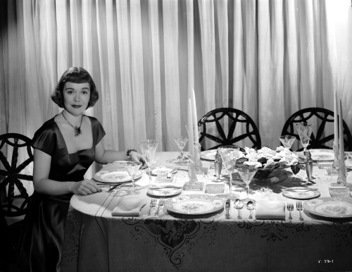 Jane Wyman Seated on the Chair in Black Velvet Short Sleeve Square-Neck Dress and Black Necklace with Hands on the Table Photo Print - Item # VARCEL705872