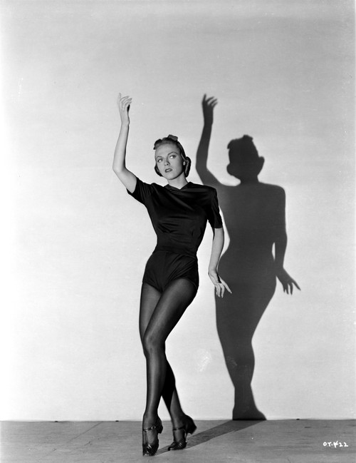 Vera Zorina wearing black leotard, black stockings, and side-clasped dance shoes, with one arm raised, and looking away from the camera Photo Print - Item # VARCEL705948
