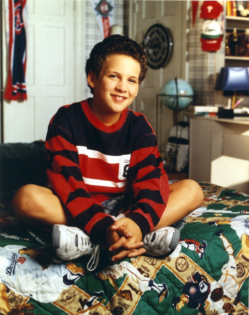 Ben Savage Seated on Printed Bed in Red Two Tone Long Sleeve Ringer Shirt and White Rubber Shoes Photo Print - Item # VARCEL706837