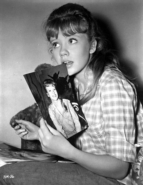 Hayley Mills wearingt a Printed Polo Holding a Photo Photo Print - Item # VARCEL707017