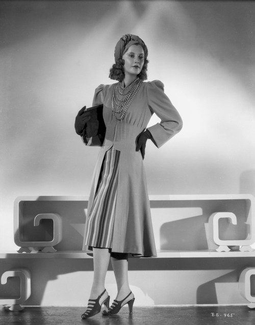 Barbara Stanwyck standing in Dress with Gloves and Cap Classic Portrait Photo Print - Item # VARCEL707465