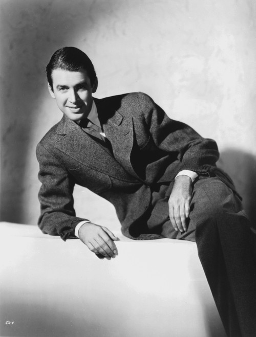 James Stewart Reclining on a White Couch in Black Linen Sport Coat and Legs Crossed with Right Arm Rest on the Lap Photo Print - Item # VARCEL707891