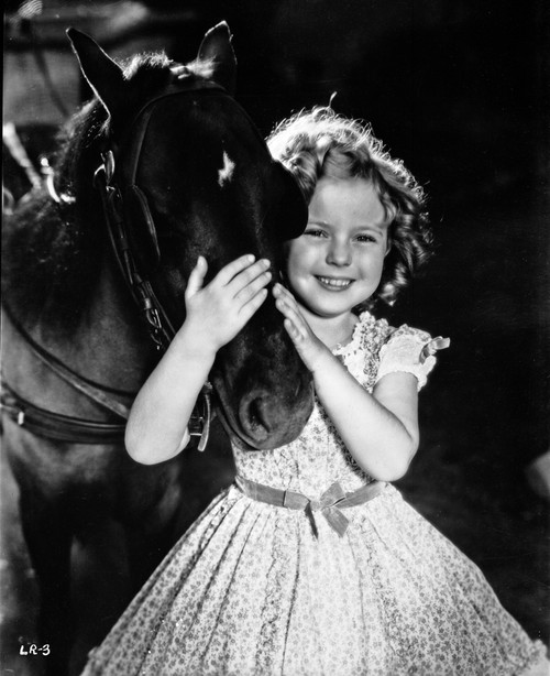 Shirley Temple Playing Horse in Floral Dress Photo Print - Item # VARCEL708456