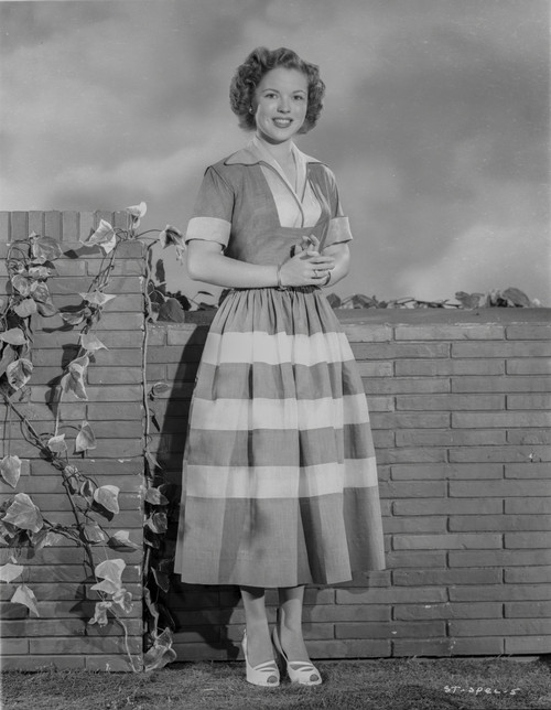Shirley Temple standing in Bricks Background Photo Print - Item # VARCEL708469