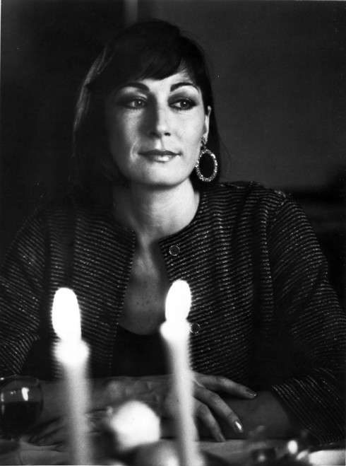 Anjelica Huston sitting at the Dining Table wearing a Loop Earring Portrait in Classic Photo Print - Item # VARCEL708501