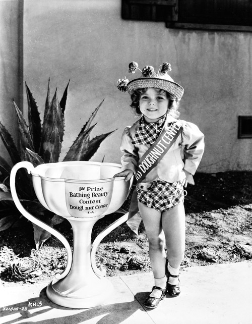 Shirley Temple Posed in cute hat with oversized trophy Photo Print - Item # VARCEL708502