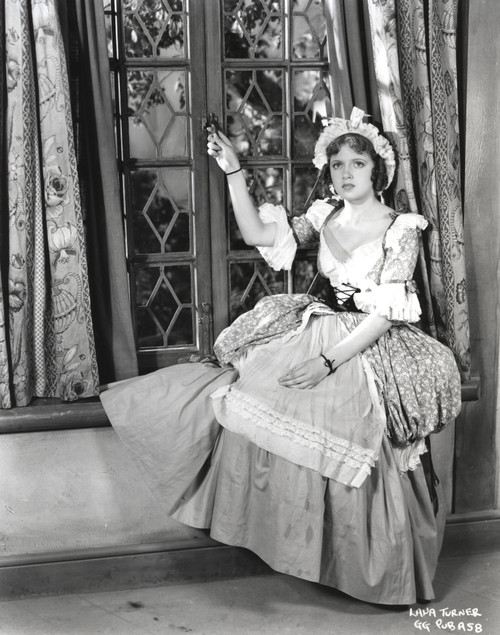 Lana Turner posed Beside the Window in Elegant Dress Photo Print - Item # VARCEL709024