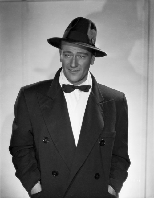 John Wayne in a bowtie coat and hat Photo Print - Item # VARCEL709216