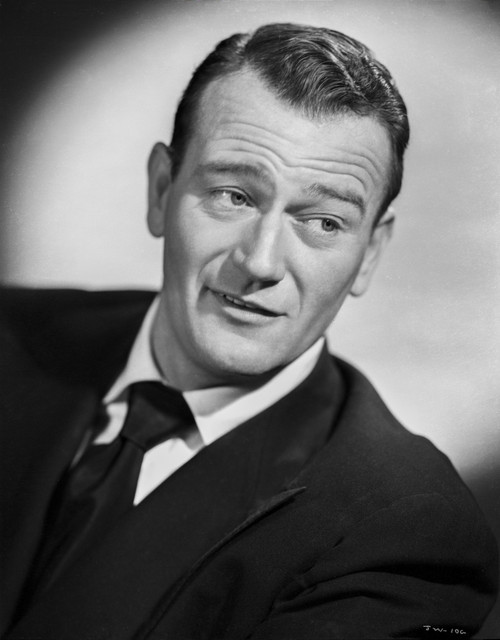 John Wayne Looking Away and wearing a Black Suit and Tie Photo Print - Item # VARCEL709239