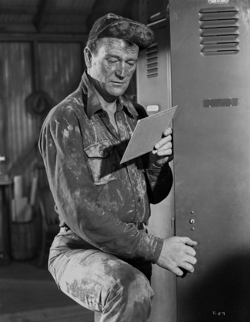 John Wayne reading paper in a hat Photo Print - Item # VARCEL709230