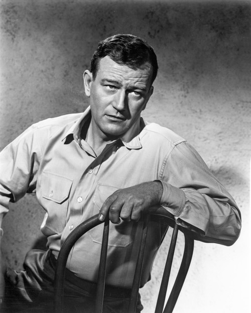 John Wayne sitting on a chair Photo Print - Item # VARCEL709271