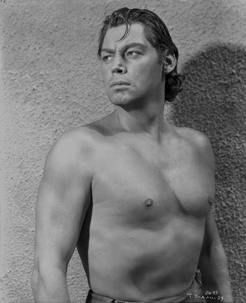 Johnny Weissmuller standing in Front of the Camera while Looking Away in a Portrait Photo Print - Item # VARCEL709319