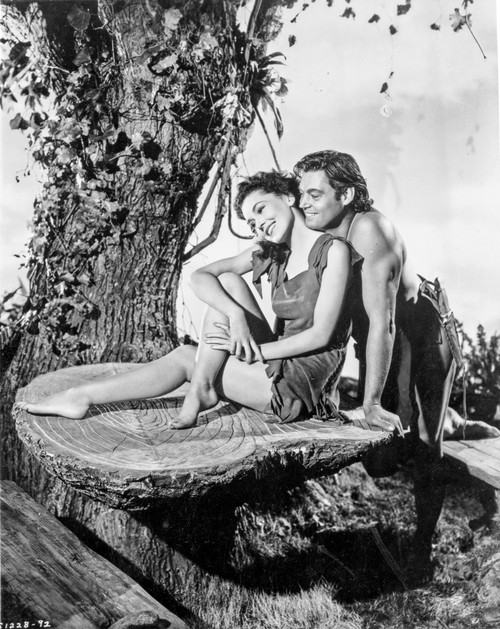 Johnny Weissmuller Making a Love Scene with a Woman in a Classic Movie Scene Photo Print - Item # VARCEL709308