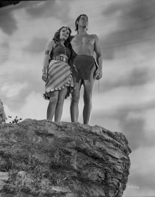 Johnny Weissmuller standing on a Cliff with a Woman in a Movie Scene Photo Print - Item # VARCEL709322