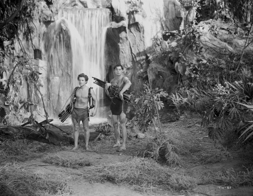 Johnny Weissmuller standing Near the Waterfalls with His Kid in a Movie Scene Photo Print - Item # VARCEL709353