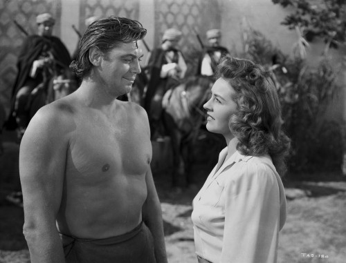 Johnny Weissmuller standing and Talking to a Girl in a Movie Scene Photo Print - Item # VARCEL709358