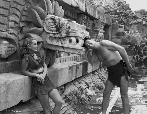 Johnny Weissmuller Sticking His Head Inside a Dragon Head Wall Decoration in a Classic Movie Scene Photo Print - Item # VARCEL709331