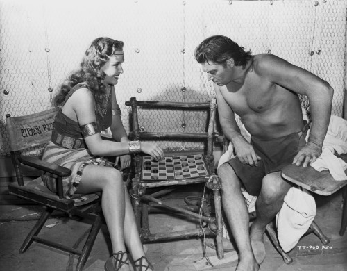 Johnny Weissmuller Playing Checkers with a Woman in a Classic Movie Scene Photo Print - Item # VARCEL709335