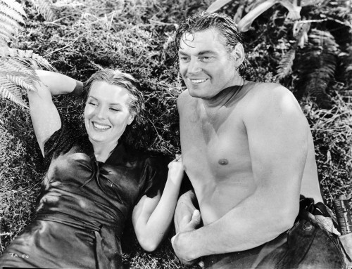 Johnny Weissmuller Lying on the Ground with a Woman in a Classic Movie Scene Photo Print - Item # VARCEL709381