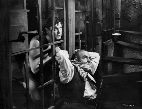 Johnny Weissmuller Tying Up a Guard in His Prison Cell Door in a Classic Movie Scene Photo Print - Item # VARCEL709360