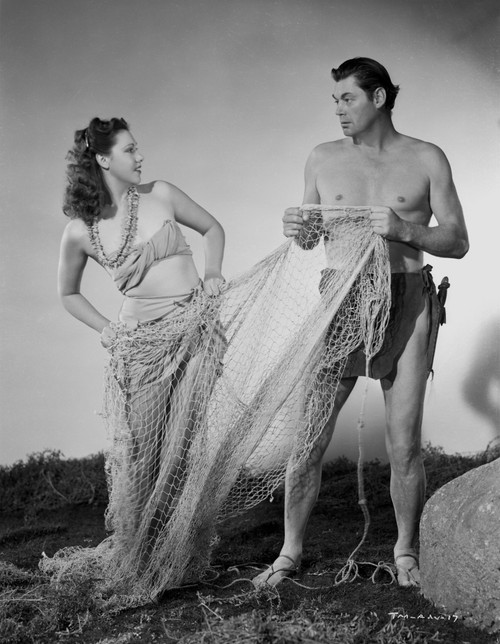 Johnny Weissmuller Holding a Fish Net with a Woman in a Classic Movie Scene Photo Print - Item # VARCEL709398