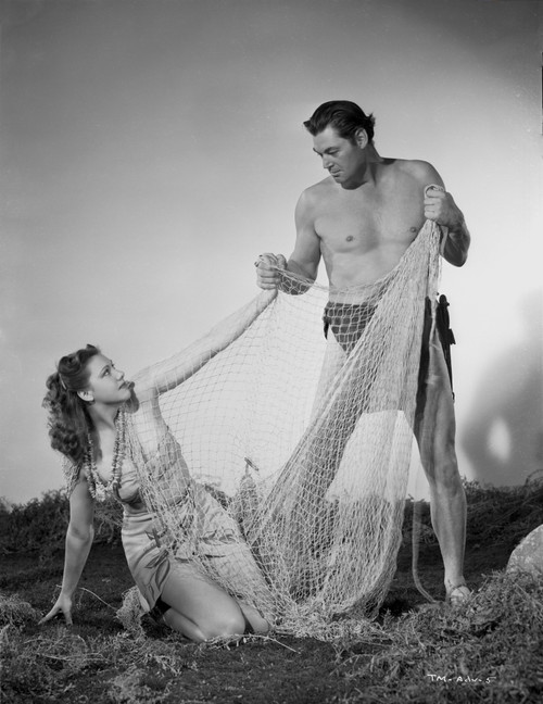 Johnny Weissmuller Holding a Fish Net in a Classic Movie Scene Photo Print - Item # VARCEL709399