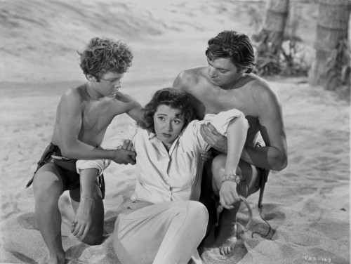 Johnny Weissmuller Helping a Woman with the Help of a Young Man in a Classic Movie Scene Photo Print - Item # VARCEL709383