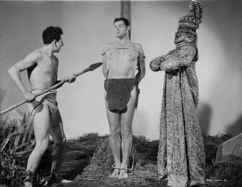 Johnny Weissmuller Tied Up in a Pole in a Classic Movie Scene Photo Print - Item # VARCEL709402