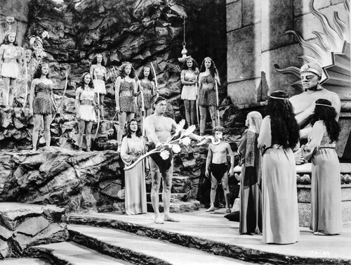 Johnny Weissmuller Presenting His Gifts in a Classic Movie Scene Photo Print - Item # VARCEL709403