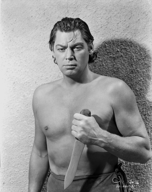 Johnny Weissmuller Holding a Knife in a Classic Movie Scene Photo Print - Item # VARCEL709405