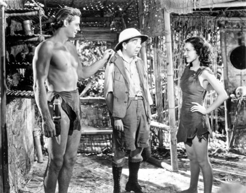 Johnny Weissmuller Watching His Girl and a Small Guy Talking in a Movie Scene Photo Print - Item # VARCEL709446