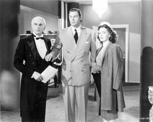 Johnny Weissmuller standing on the Office with an Old Man and a Lady in Classic Movie Scene Photo Print - Item # VARCEL709440