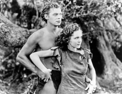 Johnny Weissmuller Holding Hands with a Woman in a Movie Scene Photo Print - Item # VARCEL709458