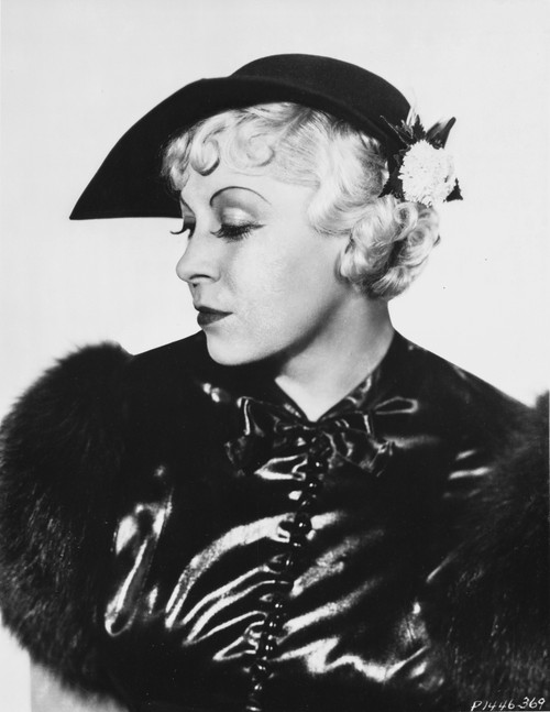 Mae West Looking Down in Glossy Black Dress with Fur Sleeves Photo Print - Item # VARCEL709626