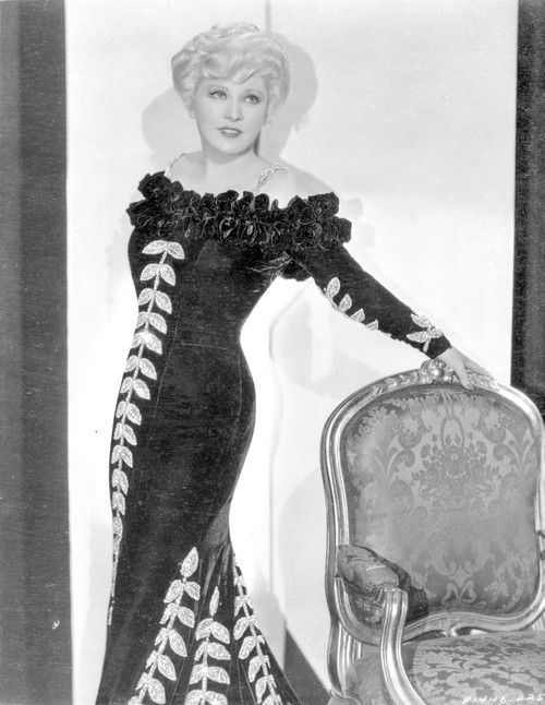 Mae West Leaning on Chair, wearing Black Dress with Curly Hairstyle Photo Print - Item # VARCEL709660
