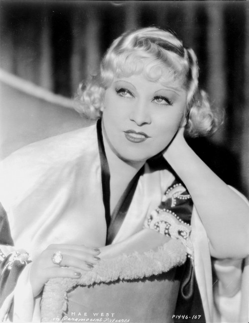 Mae West sitting in White Robe with Head Leaning on Hand Photo Print - Item # VARCEL709674