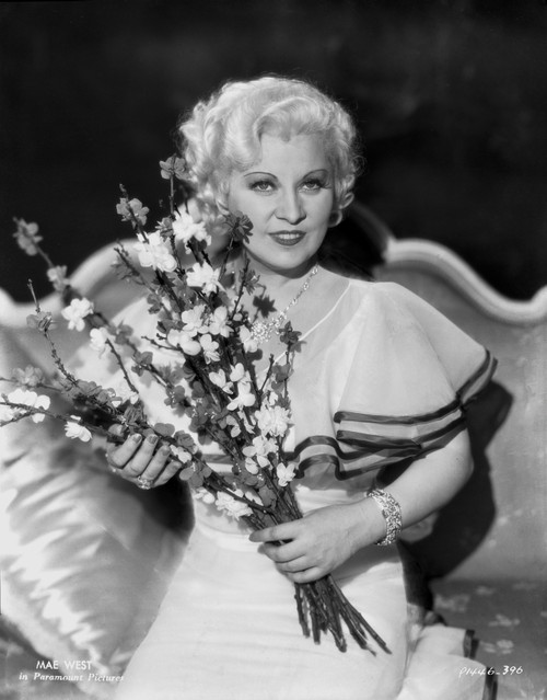 Mae West smiling in a Couch with Flowers Photo Print - Item # VARCEL709701