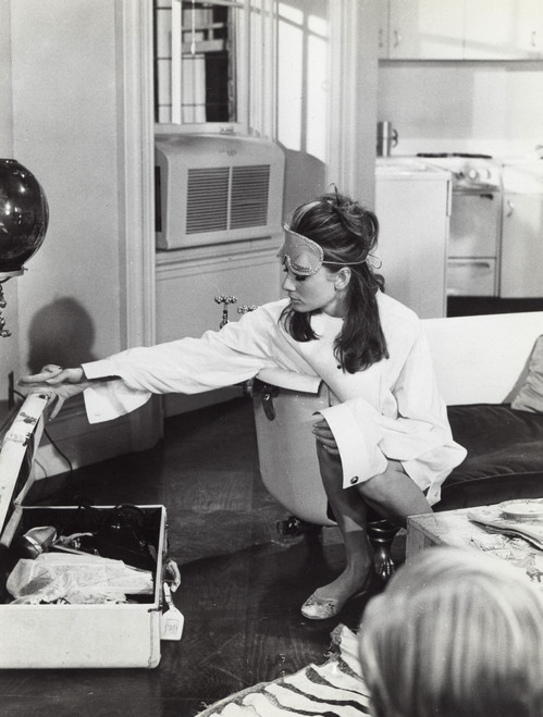 Film still of Audrey Hepburn wearing an eye mask and packing a suitcase Photo Print (8 x 10)